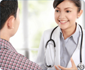 A woman in white coat talking to a man.