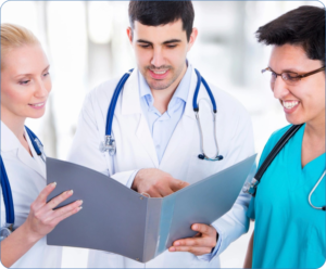 Three doctors are looking at a book.